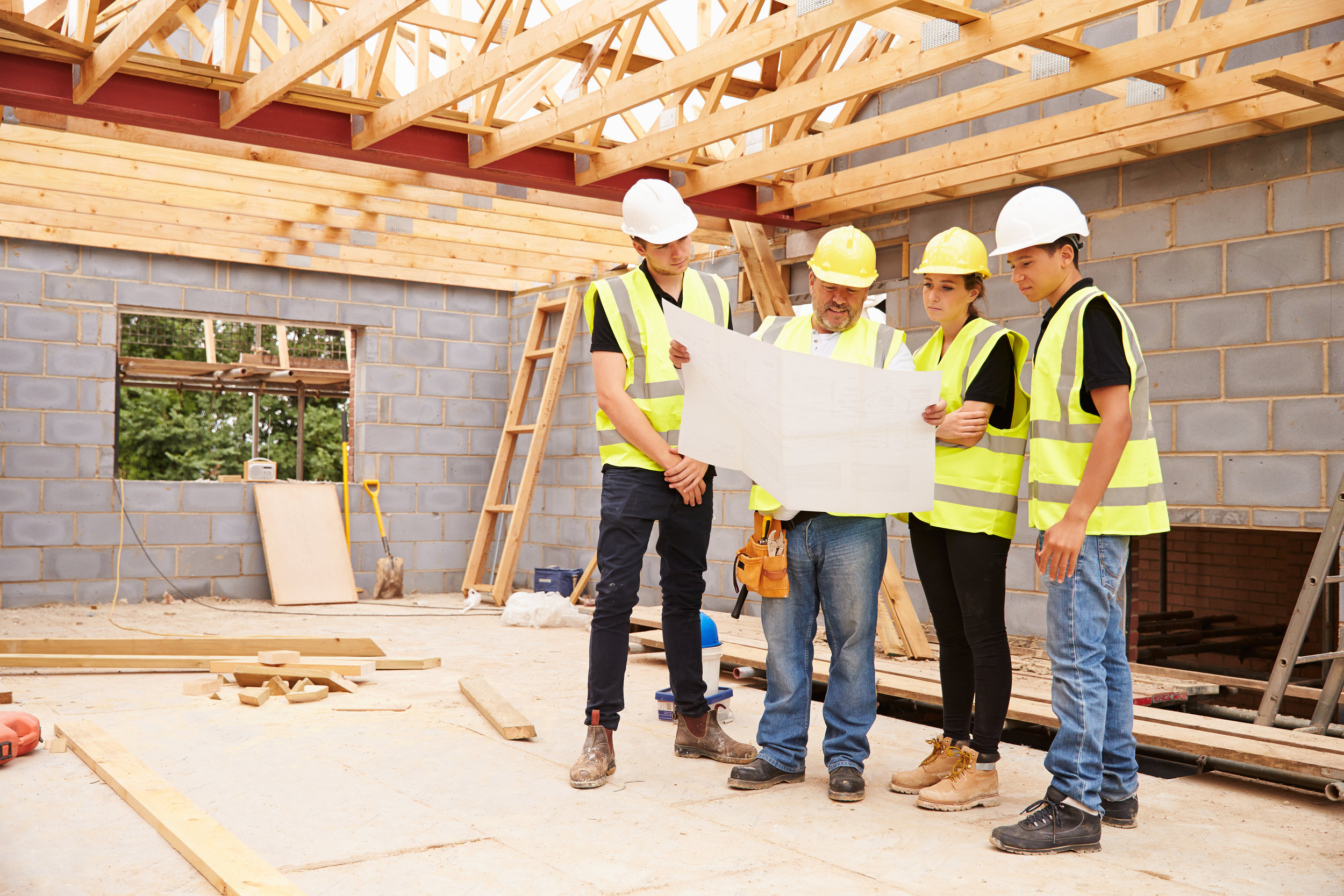 construction workers consulting blueprints